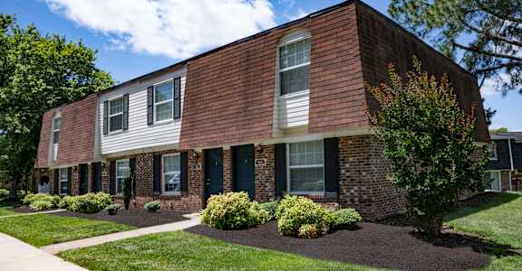 A brick building with white trim and windows.