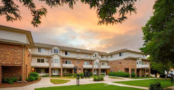 Apartment complex with a grassy area in front.