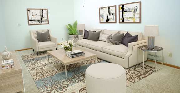 a living room with light blue walls and a beige couch