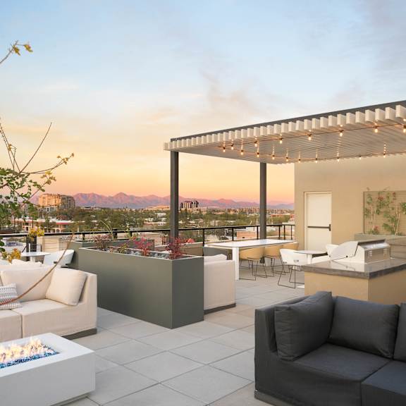 A modern outdoor living space with a fire pit and comfortable seating.