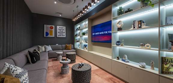 a living room filled with furniture and a display case