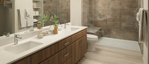A bathroom with brown tiles and a white sink.