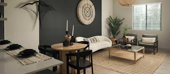 A modern living room with a dining table and chairs.