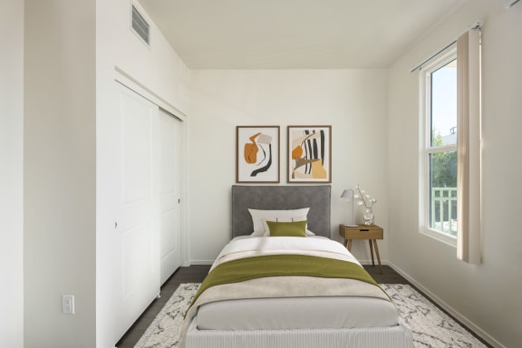 a bedroom with a bed and pictures on the wall