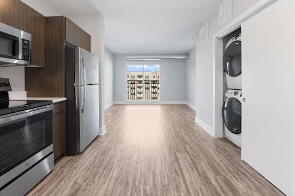 A modern kitchen with wooden cabinets and stainless steel appliances.