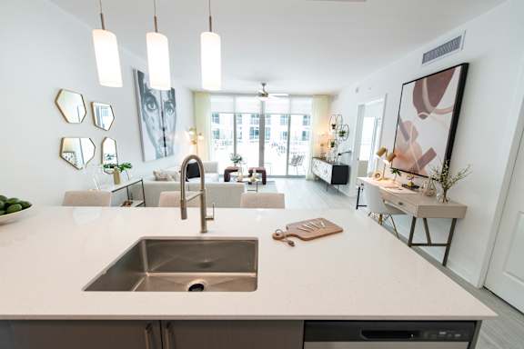A modern kitchen with a large island and a stainless steel sink.