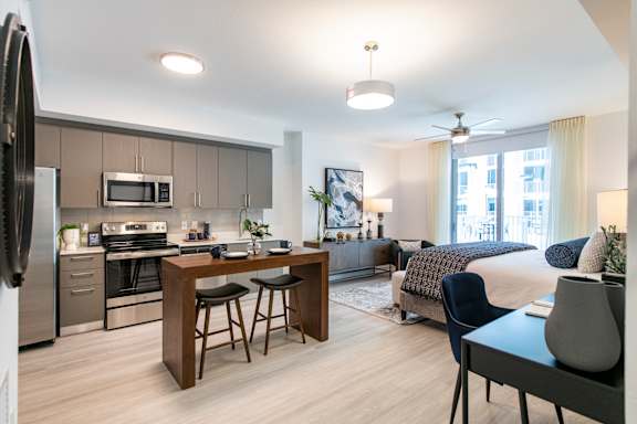 A modern kitchen with a dining table and chairs.