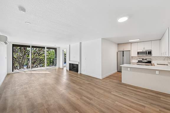 A spacious kitchen with a countertop and a refrigerator.
