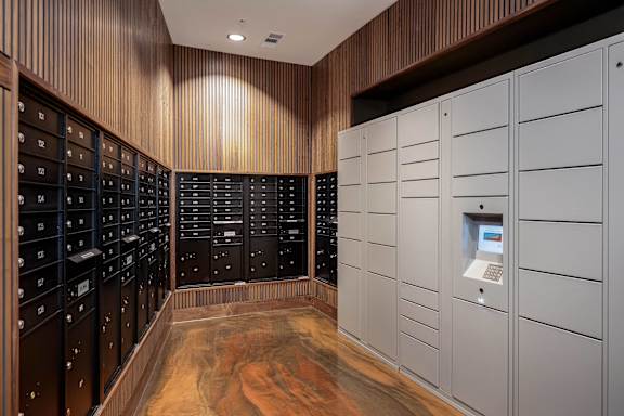 a wine cellar with white cabinets and wooden floors and a machine in the middle