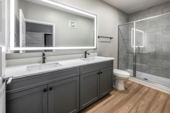 a bathroom with a sink and a toilet and a shower at The Haven at Lake Britt Apartments, Winter Garden, FL 34787