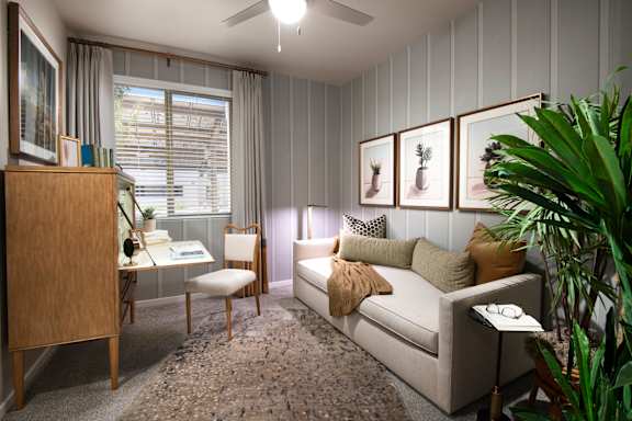 A living room with a couch, chair, and a cabinet.