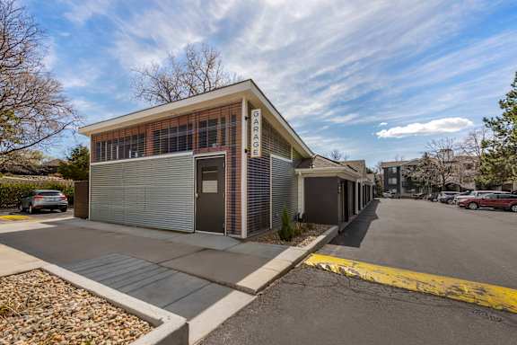 a small building with a parking lot in front of it