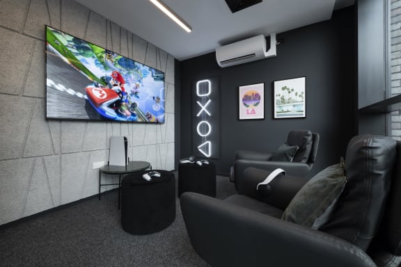a living room with couches and a tv on the wall
