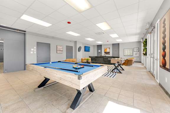 A spacious gym with a variety of equipment and a skylight.