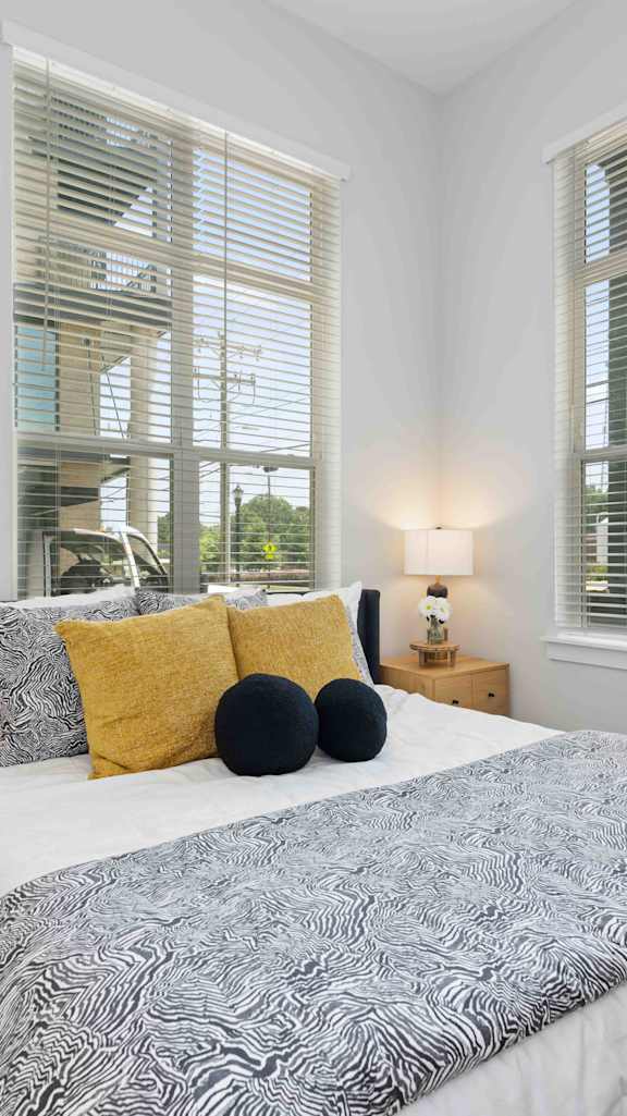 a bedroom with a bed and some windows