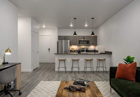 an open kitchen with a bar and a living room