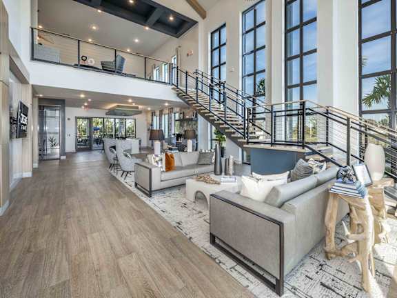 A modern living room with a staircase and a couch.