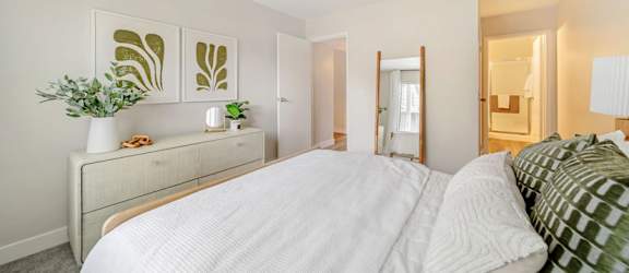 a bedroom with a large bed and a dresser with a plant on it  at Citrine Hills, California, 91761
