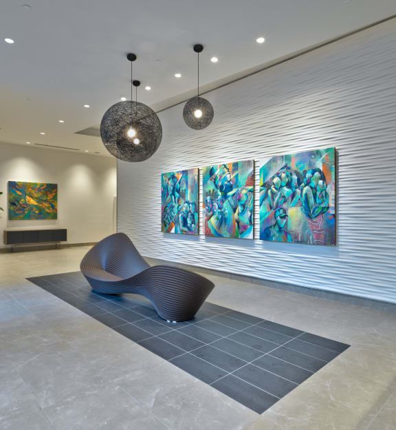 the lobby of an office building with a reception desk and a wall of refrigerators