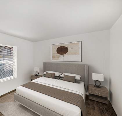 a bedroom with a bed and a potted plant