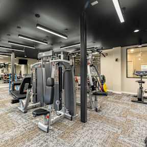 A gym with a variety of equipment including a leg press machine.
