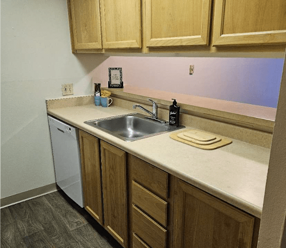 a kitchen with a sink and wooden cabinets