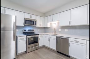 white kitchen with stainless steal appliances