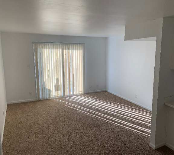 a living room with a couch and a table and a television