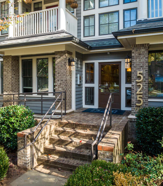 A house numbered 525 with a front porch and steps leading up to the entrance.