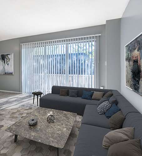 A pool with a blue umbrella and a building in the background.