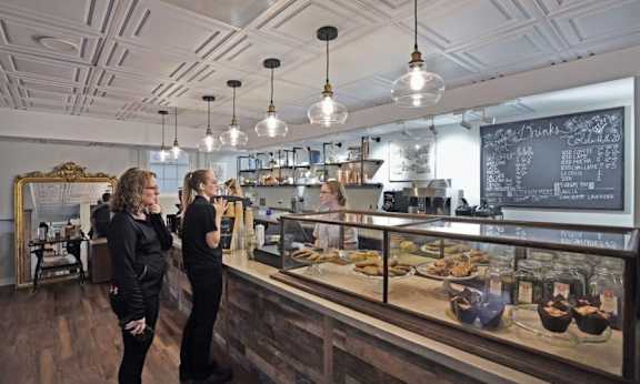 Customers ordering coffee and doughnuts at Dough-Joe’s in Reynolda Village Winston-Salem NC near Sugar Creek Apartments and Wake Forest University.