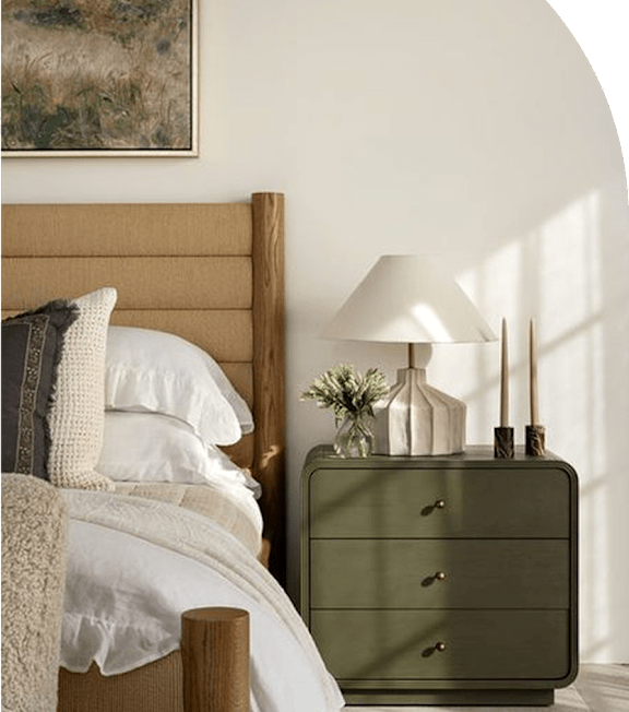 A bed with a green chest of drawers and a lamp on top of it.