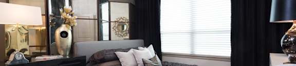 bedroom with large window and ceiling fan