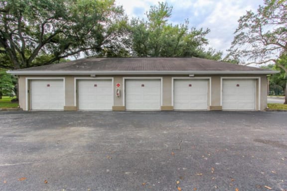 5 Detached Garages in Parking Lot with Trees in the Background