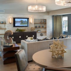 a living room with a table and a couch and a tv