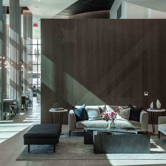 a living room with a sofa and coffee table in front of a large wall with a star at Altaire, Arlington, Virginia