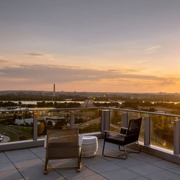 a balcony with two chairs and a table at Altaire, Arlington, Virginia