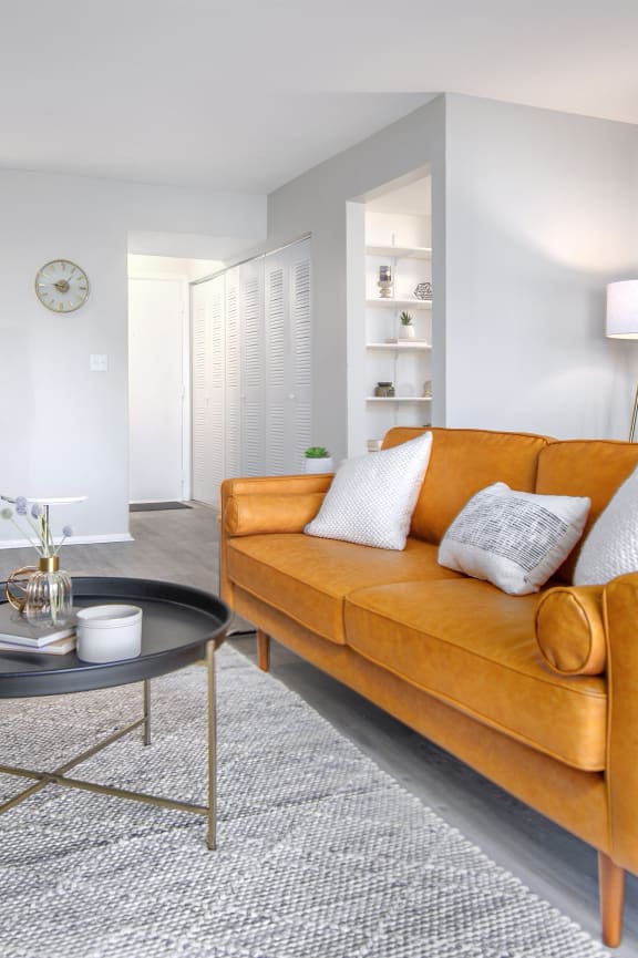 a living room with an orange couch and a table
