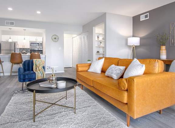 a living room with an orange couch and a table
