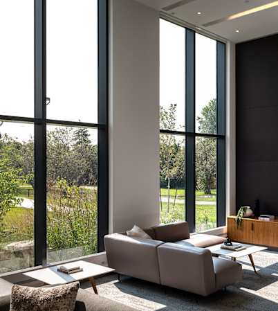 a living room with couches and a television on the wall