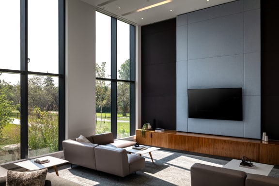 a living room with couches and a television on the wall