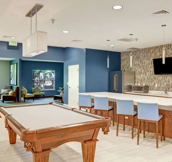 a game room with a pool table and a bar