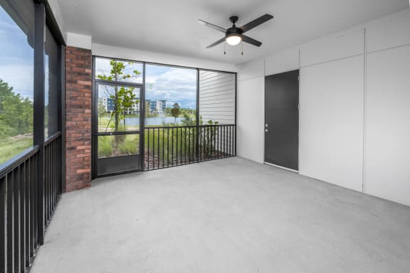 an empty living room with a large window and a ceiling fan at The Haven at Lake Britt Apartments, Winter Garden, FL 34787