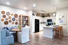 a living room and kitchen with a table and chairs