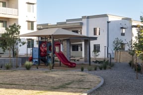 a childrens playground in front of a house
