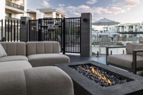 a living room with couches and a fire pit