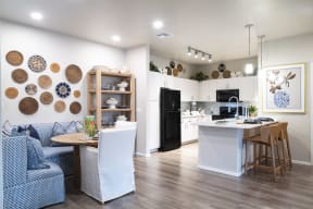 a living room and kitchen with a table and chairs