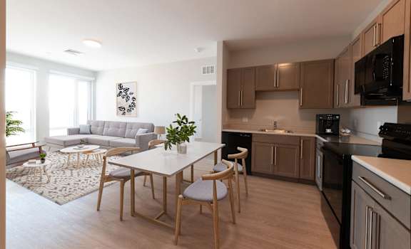 A modern kitchen with a dining table and chairs. at The Anne M. Lynch Homes at Old Colony, Massachusetts, 02127