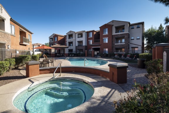 a jacuzzi and hot tub in a resort style pool with an apartment