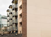 Thumbnail 2 of 3 - a building with balconies and a cloudy sky in the background